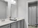 Well-lit bathroom featuring a double vanity with gray cabinets and a separate shower area at 523 Kilarney Rd, Summerville, SC 29483