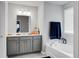 Bright bathroom featuring a modern vanity, soaking tub, and large window at 523 Kilarney Rd, Summerville, SC 29483