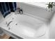 Close up of the bathtub, which has a chrome faucet and adjacent windowsill with toiletries and plants at 523 Kilarney Rd, Summerville, SC 29483