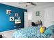 Stylish bedroom with blue accent wall, playful art, and comfortable bed at 523 Kilarney Rd, Summerville, SC 29483