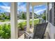 Cozy front porch featuring classic columns, comfortable seating, and a view of the quiet neighborhood at 523 Kilarney Rd, Summerville, SC 29483