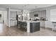 Spacious kitchen featuring a center island with seating, stainless steel appliances, and ample cabinet space at 523 Kilarney Rd, Summerville, SC 29483