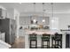 Bright kitchen features gray cabinetry, granite countertops, stainless steel appliances and an island with bar stool seating at 523 Kilarney Rd, Summerville, SC 29483