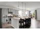 Open-concept kitchen with stainless steel appliances, island seating, granite counters and sliding glass door at 523 Kilarney Rd, Summerville, SC 29483