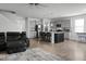 Open-concept living room, dining and kitchen area provides an airy atmosphere with hardwood floors and lots of light at 523 Kilarney Rd, Summerville, SC 29483