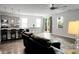 Open-concept living room and kitchen area with hardwood floors and lots of natural light at 523 Kilarney Rd, Summerville, SC 29483