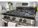 Close up of a stainless steel gas stove with granite countertops in the background, showing modern kitchen details at 523 Kilarney Rd, Summerville, SC 29483
