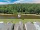 Overhead view of homes backing to a lake with a fountain and wooded scenery at 548 Sea Foam St, Summerville, SC 29486