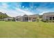 Spacious backyard view showcasing multiple homes with screened porches and green lawn at 548 Sea Foam St, Summerville, SC 29486