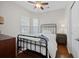 Bedroom with hardwood floors, black metal bed, and windows with blinds at 548 Sea Foam St, Summerville, SC 29486