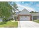 Charming home exterior with stone accents, manicured lawn, and two-car garage at 548 Sea Foam St, Summerville, SC 29486