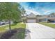 Well-maintained home with green lawn, brick driveway, and attached garage at 548 Sea Foam St, Summerville, SC 29486