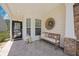 Charming front porch featuring a bench, decorative wreath, and stylish lanterns, perfect for relaxing outdoors at 548 Sea Foam St, Summerville, SC 29486