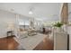 Bright living room with hardwood floors, large windows, a comfortable sofa, and stylish decor at 548 Sea Foam St, Summerville, SC 29486
