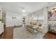 Cozy living room with hardwood floors, a plush sofa, and modern decor, ideal for relaxation and gatherings at 548 Sea Foam St, Summerville, SC 29486
