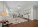Spacious living room with hardwood floors, an elegant chandelier, and an open layout, great for entertaining at 548 Sea Foam St, Summerville, SC 29486