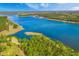 Scenic aerial shot of a pristine lake bordered by verdant forests on a sunny day at 627 Chigwell Springs Ln, Summerville, SC 29486