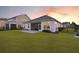 Spacious backyard with vibrant green grass, patio, and a screened porch, ideal for outdoor enjoyment at 627 Chigwell Springs Ln, Summerville, SC 29486