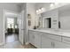 This bathroom features a double vanity, soft lighting, and access to the bedroom at 627 Chigwell Springs Ln, Summerville, SC 29486