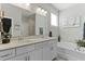 This bathroom includes a double vanity, a soaking tub, and soft, neutral colors at 627 Chigwell Springs Ln, Summerville, SC 29486