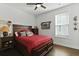 Comfortable bedroom featuring a wood bed frame, ceiling fan, natural light, and hardwood floors at 627 Chigwell Springs Ln, Summerville, SC 29486