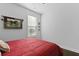 Simple bedroom featuring red and white striped bedspread, natural light, and a decorative horse print at 627 Chigwell Springs Ln, Summerville, SC 29486