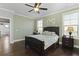 This bedroom features a ceiling fan, beautiful hardwood floors and multiple windows for great natural light at 627 Chigwell Springs Ln, Summerville, SC 29486