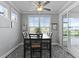 Cozy dining area features a ceiling fan, windows and sliding glass door to a patio at 627 Chigwell Springs Ln, Summerville, SC 29486