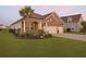 Charming brick home with a lush lawn, complemented by a stately palm tree at 627 Chigwell Springs Ln, Summerville, SC 29486