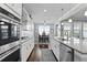 Open, white kitchen with dining area featuring stainless appliances, granite counters, and luxury finishes at 627 Chigwell Springs Ln, Summerville, SC 29486