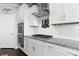 Bright kitchen boasts stainless appliances, granite counters, subway tile, and custom stove hood at 627 Chigwell Springs Ln, Summerville, SC 29486