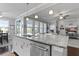 Kitchen island with granite counters and stainless dishwasher overlooks dining and living area at 627 Chigwell Springs Ln, Summerville, SC 29486