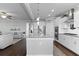 Open concept kitchen with large island, stainless appliances, and seamless flow to living room at 627 Chigwell Springs Ln, Summerville, SC 29486