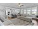 Bright living room showcasing an open layout with modern kitchen access at 627 Chigwell Springs Ln, Summerville, SC 29486