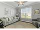 The cozy living room is complemented by natural light from a large window at 627 Chigwell Springs Ln, Summerville, SC 29486
