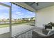 Screened-in patio overlooking a tranquil lake and landscaped backyard, perfect for outdoor relaxation and entertainment at 627 Chigwell Springs Ln, Summerville, SC 29486