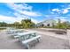 Outdoor picnic area featuring several light-blue picnic tables set on a gravel area with green landscaping at 627 Chigwell Springs Ln, Summerville, SC 29486