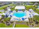 Aerial view of a luxurious community pool surrounded by lounge chairs, umbrellas, and lush landscaping at 627 Chigwell Springs Ln, Summerville, SC 29486