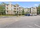Multi-level condominium building with outdoor balconies and parking area at 700 Daniel Ellis Dr # 11302, Charleston, SC 29412