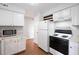 Functional kitchen area with appliances, white cabinets and wood floors at 700 Daniel Ellis Dr # 11302, Charleston, SC 29412