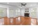 Bright living room with fireplace, wood floors, ceiling fan and natural light at 700 Daniel Ellis Dr # 11302, Charleston, SC 29412
