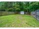 Spacious backyard with a storage shed surrounded by lush greenery and a wood privacy fence at 717 Temple Road # B, Ladson, SC 29456