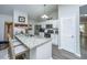 Clean white kitchen features granite countertops, stainless steel appliances and a breakfast bar at 717 Temple Road # B, Ladson, SC 29456