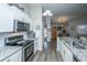 Modern kitchen with stainless steel appliances, granite countertops, and hardwood floors at 717 Temple Road # B, Ladson, SC 29456