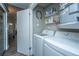 Bright laundry room features newer appliances and built-in shelving for convenient storage solutions at 717 Temple Road # B, Ladson, SC 29456