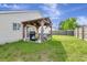 Backyard showcasing patio with grill, green lawn, and wooden fence surround at 7838 Long Shadow Ln, North Charleston, SC 29406