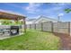 Spacious backyard with lawn, wooden fence, and a covered patio area at 7838 Long Shadow Ln, North Charleston, SC 29406