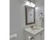 Bathroom featuring a single sink vanity, decorative mirror, and modern lighting at 7838 Long Shadow Ln, North Charleston, SC 29406
