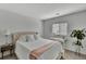 Bedroom featuring a queen bed, bedside table, and a bright window view at 7838 Long Shadow Ln, North Charleston, SC 29406