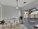 A cozy breakfast nook with modern seating, a stylish pendant light, and sliding glass doors leading to the patio at 7838 Long Shadow Ln, North Charleston, SC 29406